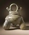 Double-spouted jar with strap handle; 500 BCE-500 CE; slip-painted ceramic; height: 21.27&nbsp;cm (8.mw-parser-output .frac{white-space:nowrap}.mw-parser-output .frac .num,.mw-parser-output .frac .den{font-size:80%;line-height:0;vertical-align:super}.mw-parser-output .frac .den{vertical-align:sub}.mw-parser-output .sr-only{border:0;clip:rect(0,0,0,0);clip-path:polygon(0px 0px,0px 0px,0px 0px);height:1px;margin:-1px;overflow:hidden;padding:0;position:absolute;width:1px}3⁄8 in.), width: 19.05&nbsp;cm (7.mw-parser-output .frac{white-space:nowrap}.mw-parser-output .frac .num,.mw-parser-output .frac .den{font-size:80%;line-height:0;vertical-align:super}.mw-parser-output .frac .den{vertical-align:sub}.mw-parser-output .sr-only{border:0;clip:rect(0,0,0,0);clip-path:polygon(0px 0px,0px 0px,0px 0px);height:1px;margin:-1px;overflow:hidden;padding:0;position:absolute;width:1px}1⁄2 in.), depth: 17.46&nbsp;cm (6.mw-parser-output .frac{white-space:nowrap}.mw-parser-output .frac .num,.mw-parser-output .frac .den{font-size:80%;line-height:0;vertical-align:super}.mw-parser-output .frac .den{vertical-align:sub}.mw-parser-output .sr-only{border:0;clip:rect(0,0,0,0);clip-path:polygon(0px 0px,0px 0px,0px 0px);height:1px;margin:-1px;overflow:hidden;padding:0;position:absolute;width:1px}7⁄8 in.); Los Angeles County Museum of Art (USA)