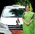 Dr. Divya S. Iyer IAS, District Collector of Pathanamthitta, standing Infront of her official vehicle. Note the red designation plate reading "ജില്ലാ കലക്ടർ" (translation: District Collector) which is written in Malayalam.  In Kerala , Toyota Innova, is the  entitled official vehicle of DCs.