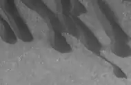 Mars Global Surveyor image of part of area in the previous photo.  The dark spots are resolved to be sand dunes.  Image taken under the MOC Public Targeting Program.