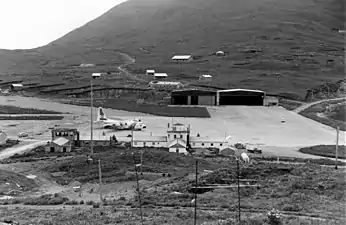 View of Dutch Harbor ramp area with a USCG C-130 Hercules in stand by for an emergency flight.