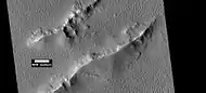 Layers and dark slope streaks in Lycus Sulci, as seen by HiRISE under HiWish program