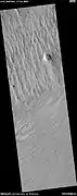 Wide view of yardangs, as seen by HiRISE under HiWish program This image is odd in that the yardangs are lined up in different directions in the top and bottom part of image.  The wind direction probably changed to cause this.