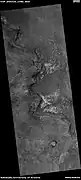 Light-toned material, as seen by HiRISE under HiWish program  Light-toned material is often associated with minerals that formed in water.