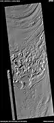 Reull Vallis floor showing lineated valley fill at the top and hollows near bottom, as seen by HiRISE under HiWish program