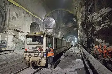 Cavern excavated as part of East Side Access, with a work train in the foreground that is dwarfed by the immensity of the freshly carved cavern.