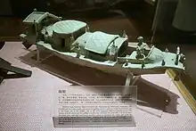An Eastern Han dynasty pottery boat model with a steering rudder at the stern and anchor at the bow.