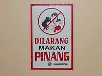 Sign in Indonesia saying that chewing betelnut is prohibited. Because of the mess, many places ban chewing betelnut. Notably, Port Moresby, the capital of Papua New Guinea, has a ban on buai. This buai ban is from Sentani Airport, Jayapura, Papua Province, Indonesia.