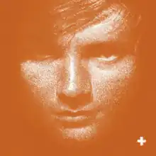 A orange-color monochrome image of a closeup of Ed Sheeran. The plus sign (+) is seen at the bottom right.