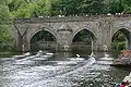 Competitors about to race through Elvet Bridge at the regatta as part of the Long Course (Newcastle University on the right)