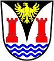 a pile embowed - Argent, on a pile embowed sable, between two towers gules and in base three barrulets wavy azure, an eagle displayed or - West Coast Peninsula Transitional Council, RSA