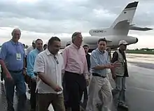 Kirchner and a group of people walking away from a plane