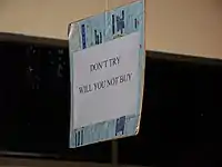 A sign in a shop in Thailand possibly asking for people to not try on the clothes