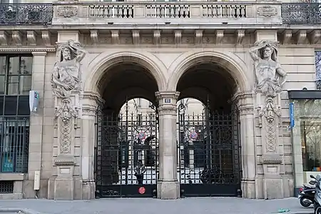 Beaux Arts atlantes at a monumental entrance on Rue du Louvre, Paris