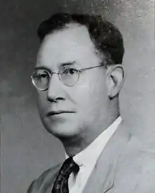 A black-and-white photographic portrait of a middle-aged Hunton from the shoulders up, wearing a suit and eyeglasses