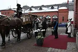 The King and Queen of Sweden with the President of Estonia, Toomas Hendrik Ilves, and his wife Evelin Ilves at the Royal Stables, entering the State Coach (2011).