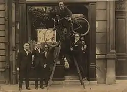 Opening of the Max Ernst exhibition at the gallery Au Sans Pareil, May 2, 1921. left to right: René Hilsum, Benjamin Péret, Serge Charchoune, Philippe Soupault (top of the ladder), Jacques Rigaut (upside down), André Breton and Simone Kahn-Breton