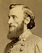 Bearded man in military uniform facing left