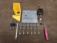 OpenBuilds V-Slot® wheels connecting plates, NEMA 17 stepper motor and bolts which assemble to make the cross slide.