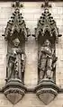 Stone sculptures of John Bradford on the left and Charles Worsley executed by Farmer & Brindley, on the main facade of Manchester Town Hall