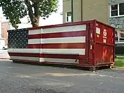 A dumpster in Chicago decorated with the American flag.