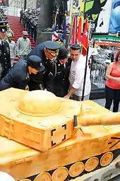 Buddy Valastro (right), General Raymond T. Odierno and other members of the United States Army in Times Square cutting a cake to celebrate the Army's 237th birthday in 2012