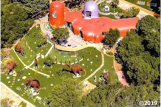 View of the Flintstone House with dinosaur sculptures installed in the backyard (2019)