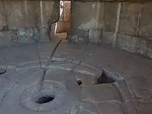 Inside: Floor of tower showing holes for mechanism