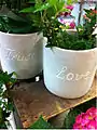 Flowerpots with the words "Trust" and "Love" on them