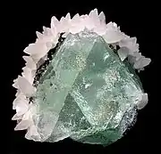 Green fluorite framed by white calcite, Naica Mine, mined in the 1980s. Size: .mw-parser-output .frac{white-space:nowrap}.mw-parser-output .frac .num,.mw-parser-output .frac .den{font-size:80%;line-height:0;vertical-align:super}.mw-parser-output .frac .den{vertical-align:sub}.mw-parser-output .sr-only{border:0;clip:rect(0,0,0,0);clip-path:polygon(0px 0px,0px 0px,0px 0px);height:1px;margin:-1px;overflow:hidden;padding:0;position:absolute;width:1px}5.5&nbsp;cm ×&nbsp;5.1&nbsp;cm ×&nbsp;4.4&nbsp;cm (2+1⁄4&nbsp;in ×&nbsp;2&nbsp;in ×&nbsp;1+3⁄4&nbsp;in).
