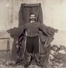 A man wearing a frame draped in material
