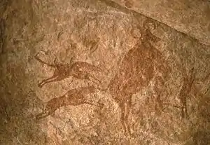 Image 10Petroglyph depicting two dogs hunting – Tassili n'Ajjer, Algeria (from Domestication of the dog)