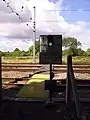The red and green stop light at an MWL foot crossing near Offord Cluny, Cambridgeshire. This is a major crossing across the high speed East Coast Main Line