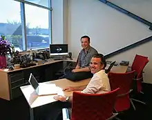 Picture of Franz von Holzhausen (front) seated in an office with Elon Musk