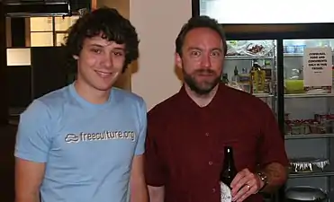 The brewer (left) with Jimmy Wales (right) and a bottle "Dana & Fred's Open source brew" (2006)