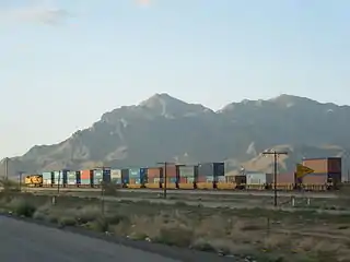 A train of well cars in Arizona carrying double-stacked containers.