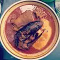 Ghanaian fufu with light soup and goat meat and smoked fish