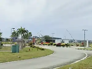 Photograph showing the main entrance to the Royal Brunei Air Force Base, Rimba, with the barrier gates in a raised position