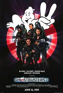 Bill Murray, Dan Aykroyd, Harold Ramis, and Ernie Hudson face the viewer. They are armed with slime throwing weapons resembling guns, with large tanks on their back. Behind them is a large logo of a "no ghosts" sign holding up two fingers. The logo "Ghostbusters&nbsp;II" is printed beneath them.