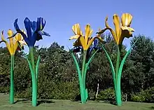 Fibre glass sculpture depicting four giant flowers, two blue and two yellow