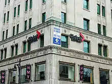 Global Montreal signs on the lower floors of a limestone-faced office building.