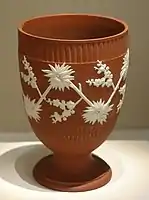 "Red" jasperware beaker, c. 1780, in "White Chinese Flowers" pattern.