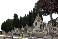 Headstones in Grand Jas Cemetery with a view of the von Derwies' chapel