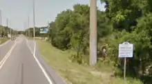 A sign advertises a small Florida community.