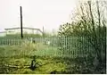Great Bridge North railway station, walking down from the crossing and past the signal box, towards the modern warehouse in 2003. The canal bridge is fenced off and collapsing.