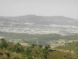 Guelma Valley as seen from Ben Djerrah, partially showing the metropolitan area of Guelma with the cities of Boumahra Ahmed, Belkheir, and Guelma visible (from right to left/east to west)