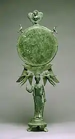 Fancy Early Classical bronze mirror with human caryatid handle, c. 460 BC