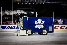 A blue coloured zamboni with a Toronto Maple Leafs logo on its side.