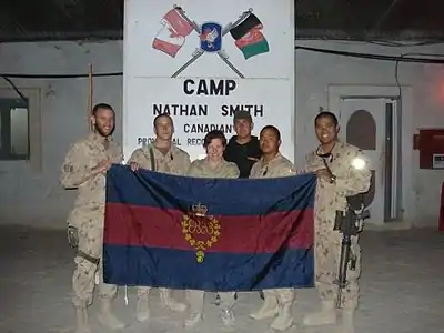 Guards holding the CGG camp flag in Kandahar