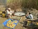 Jaggery (gur) making at small scale near sugarcane farm in Pakistan.