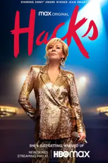 The poster shows lead character Deborah Vance in  gold sequined suit holding a microphone. Hacks is in large type behind her.